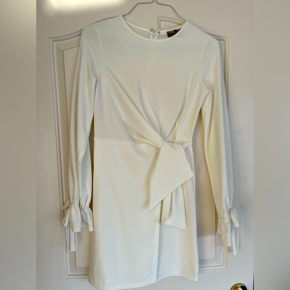 White above the knee long sleeve dress with bow tie detail